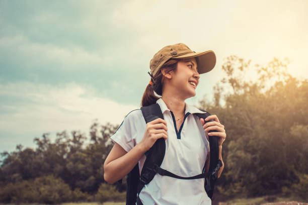 Young Asian woman backpacker in the forest.