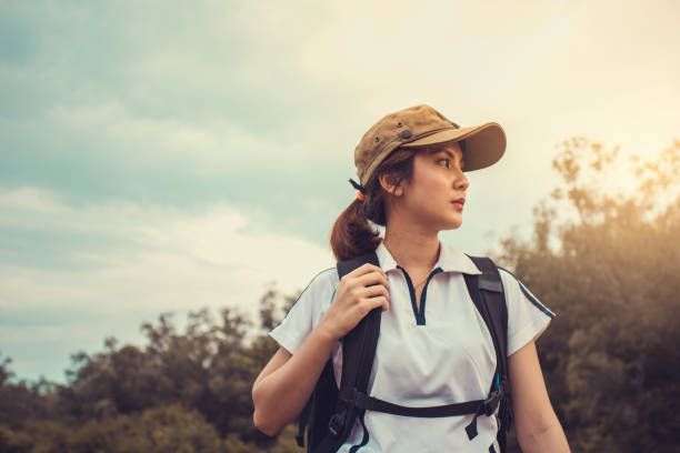 istock Young Asian woman backpacker in the forest. 1335008792