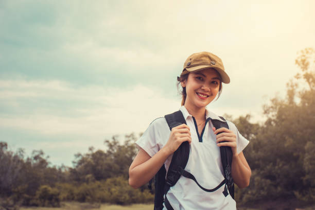 istock Young Asian woman backpacker in the forest. 1335008800