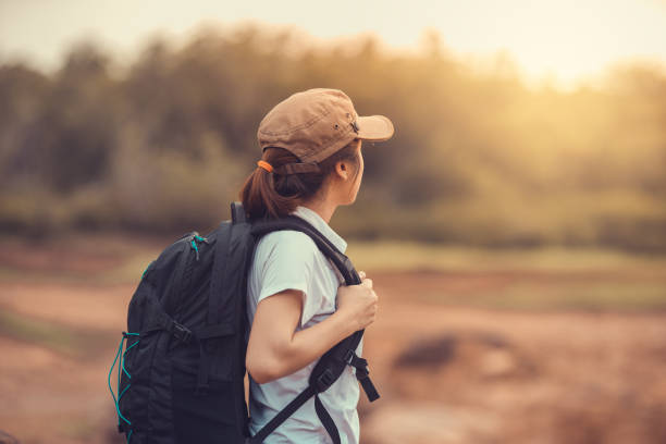 Young Asian woman backpacker in the forest.