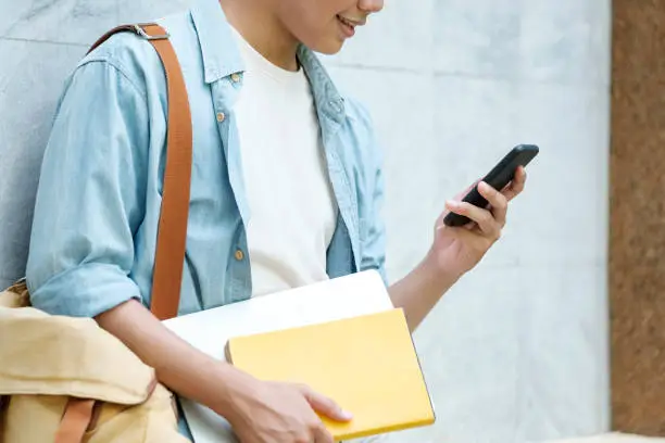 Young man using mobilephone. Online communication concept.