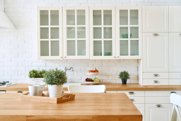 istock Kitchen wooden table top and kitchen blur background interior style scandinavian 1335009590