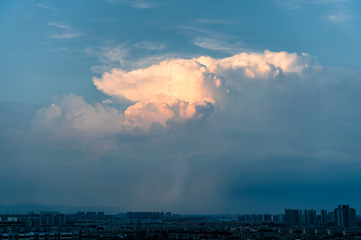 Cumulonimbus clouds over the city at sunset