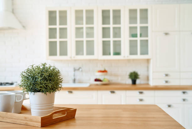 istock Kitchen wooden table top and kitchen blur background interior style scandinavian 1335009984