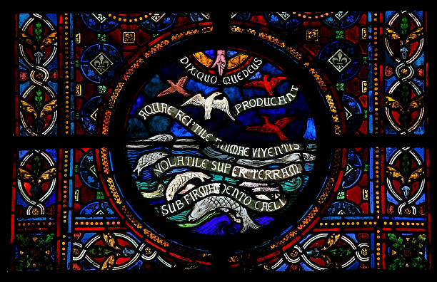 Stained glass window in the Notre Dame church of Dinant, Belgium, created in 1821, depicting the bible verses from Genesis 1: 20-23 \
