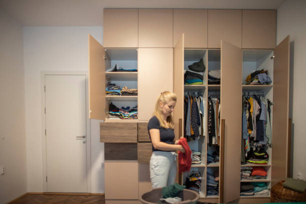 istock Young woman cleaning up the closet 1335010619