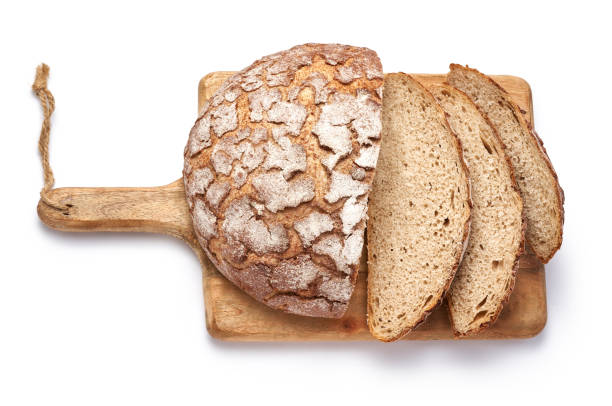 istock Sliced bread on wooden cutting board isolated on white background. Top view. 1335010811