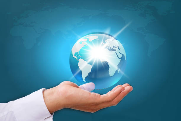 istock Human hand holding earth globe on blue  background, Global networking connection and data exchanges, global communication network concept 1335012678