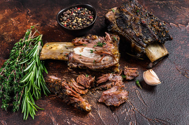 istock BBQ Grilled short beef ribs on a kitchen table. Dark background. Top view 1335012853