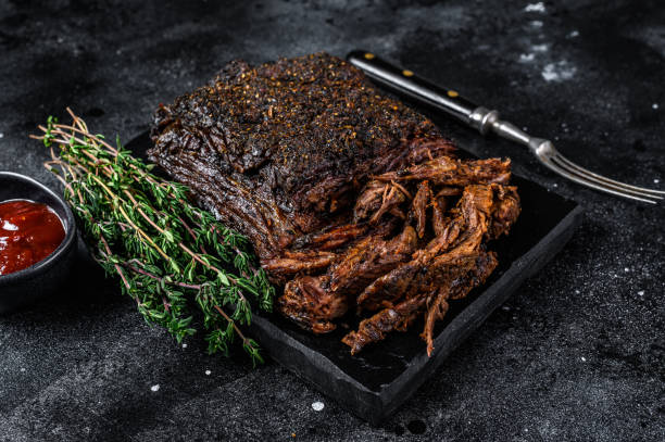 istock Texas Style BBQ Smoked Beef Brisket meat steak. Black background. Top view 1335014012