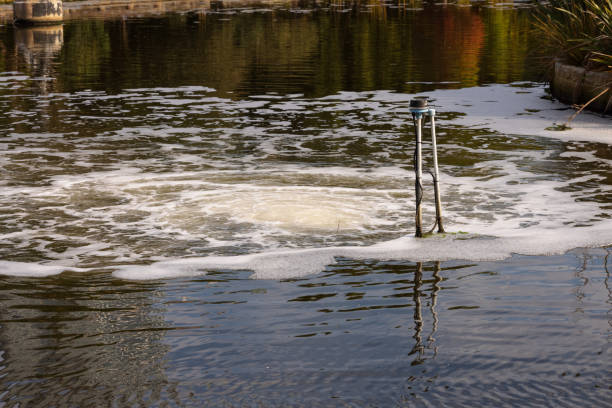 Large water pump in a pond in a public park.