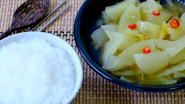 Porridge (congee) with pickled lettuce Porridge (congee) with pickled lettuce, Chinese traditional breakfast. cabbage coral photos stock pictures, royalty-free photos & images
