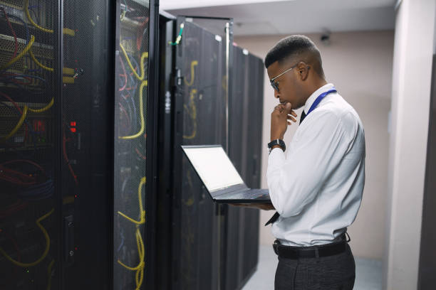 istock Shot of a young male technician working in a server room 1335018756