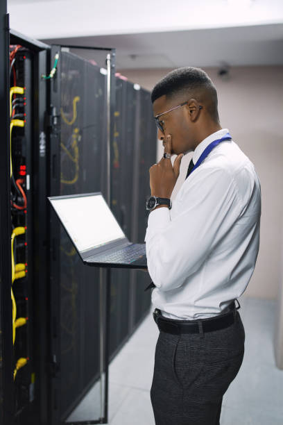 istock Shot of a young male technician working in a server room 1335018760
