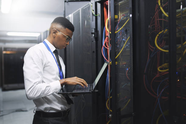 istock Shot of a young male technician working in a server room 1335018766