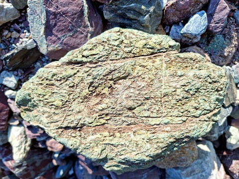 The Verrucan Stone is a sediment conglomerate from the permian period. It consists of silicoplastics and vulcanic source. The Verrucano stones from switzerland (canton glarus and graubuenden) appear often in green ord red colurs. The close-up image was captured in the canton of glarus.
