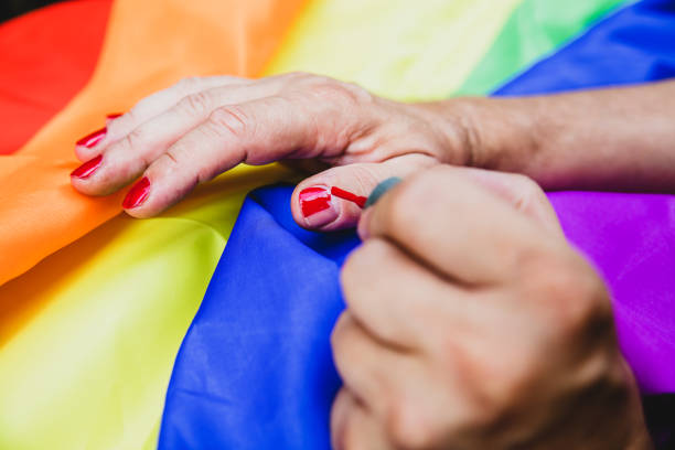 istock a man paints his fingernails with red nail polish 1335020251