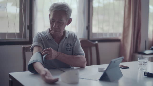 Senior man checkup with blood pressure gauge