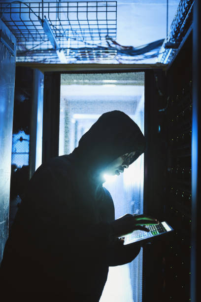 istock Shot of a hacker using a digital tablet in a server room 1335021170