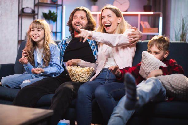 istock Parents with kids watching comedy with toothy smile on faces 1335022472
