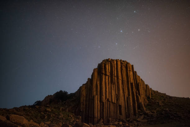 istock Basaltic rock pillar and Cassiopeia star sky 1335023791
