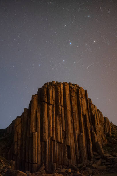 istock Basaltic rock pillar and Cassiopeia star sky 1335023829