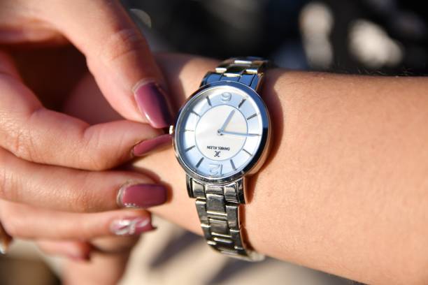 istock Woman winding wrist watch 1335024648