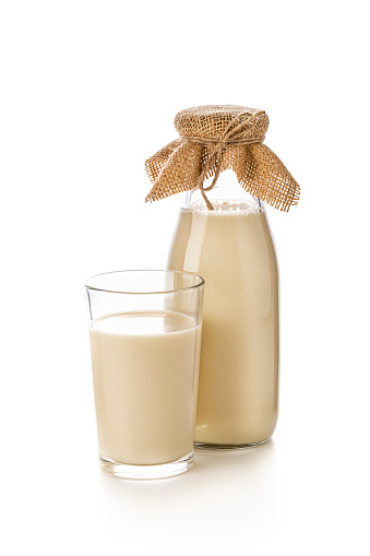 Glass and bottle full of soy milk isolated on white