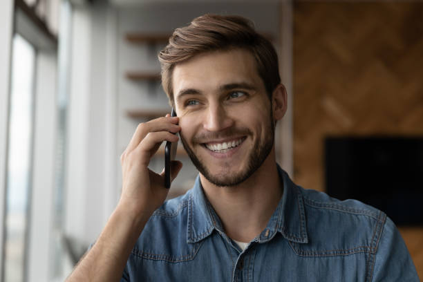 istock Happy positive millennial man making call, talking on cellphone 1335027243