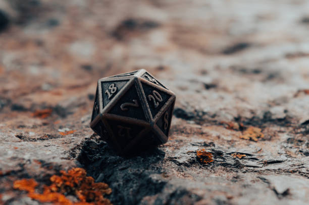istock An image of a metallic d20 on a rocky surface 1335027426