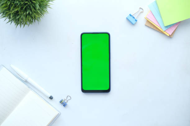 istock top view of smart phone and notepad on white background 1335031796