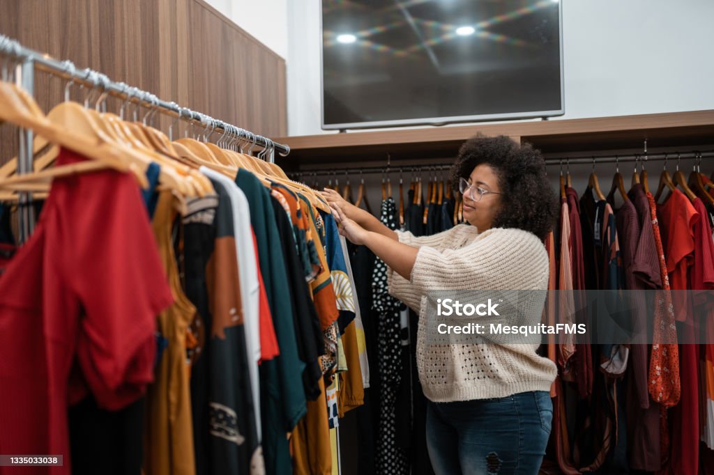 Afro woman buying clothes Shop, Shopping, Consumerism, Selling, Market Clothing Stock Photo