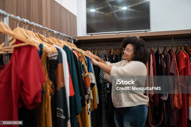 Afro Woman Buying Clothes Stock Photo - Download Image Now - Clothing, Retail, Shopping