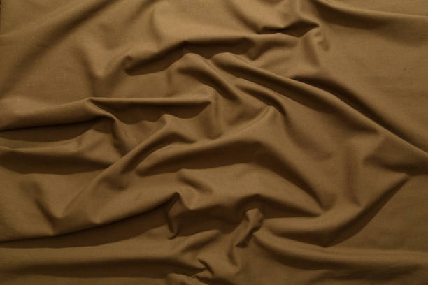 istock crumpled khaki tan crumpled tan khaki canvas fabric - full frame background and texture 1335033157