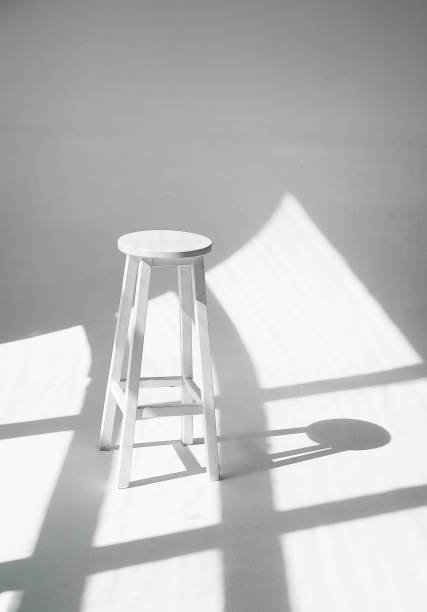 istock White chair in white color with hard shadows. 1335035241