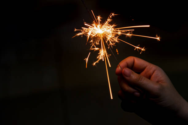 istock Female hand holding a burning sparkler, 1335037934