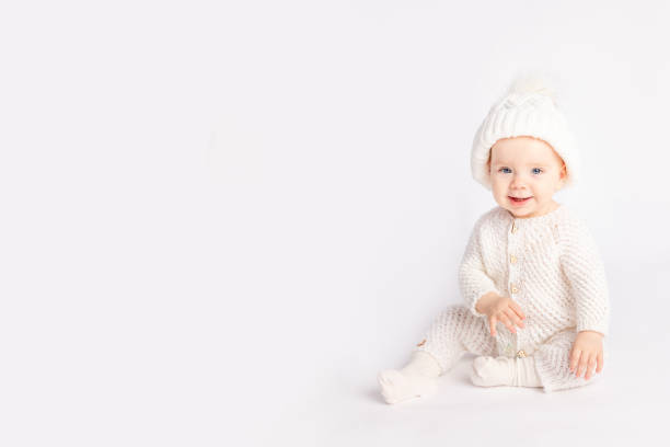 istock baby in a warm suit and hat on a white isolated background, space for text 1335038304
