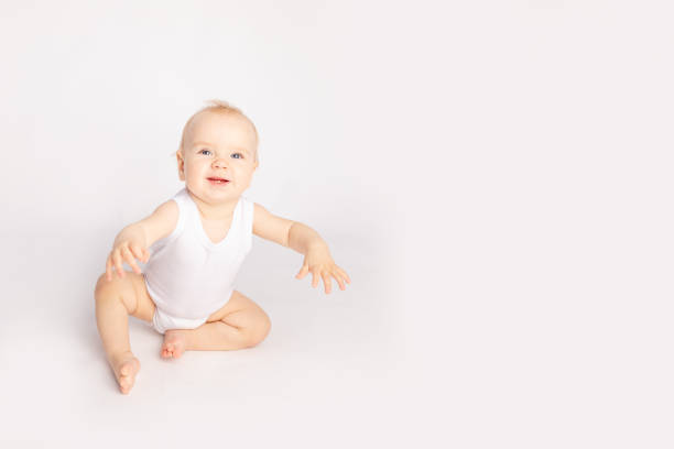 istock happy little child sitting on white isolated background 1335038327