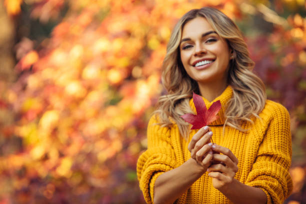 istock Beautiful woman holding a leaf 1335042153