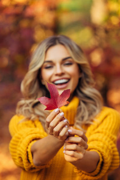istock Beautiful woman holding a leaf 1335042193