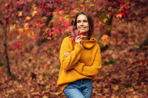 istock Beautiful woman holding a leaf 1335042248