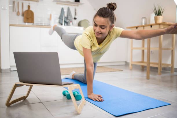 istock Girl exercising with an online coach 1335042273