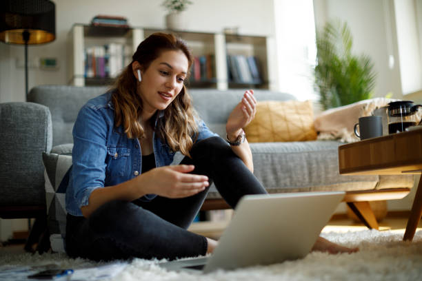 istock Young smiling woman having video call on laptop computer at home 1335042599