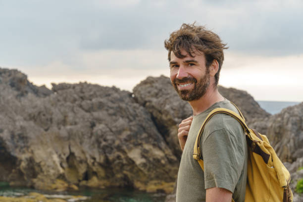 istock Adventurous man hiking in a cliff. 1335043891