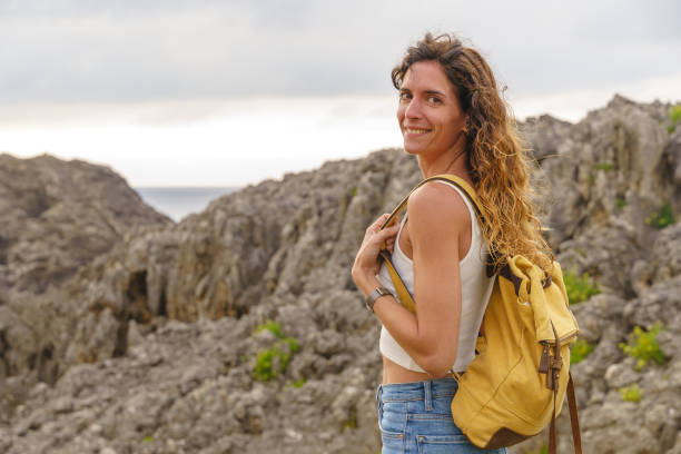 istock Adventurous woman hiking in a cliff. 1335043896