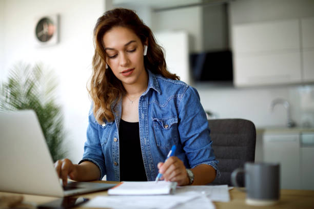 istock Young woman with bluetooth headphones working at home 1335044008