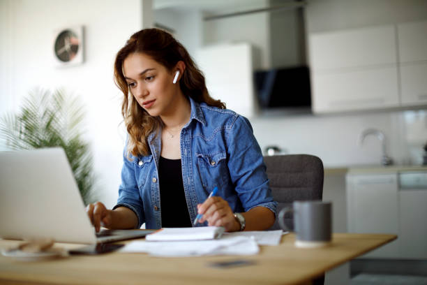 istock Young woman with bluetooth headphones working at home 1335044009