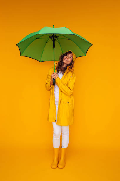 istock Girl with green umbrella 1335044793