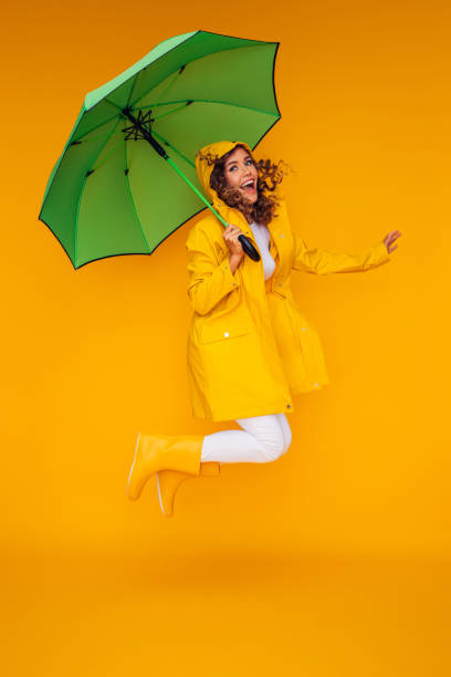 istock Girl with green umbrella 1335044827