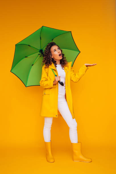 istock Girl with green umbrella 1335044850